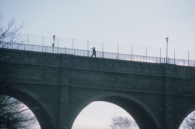a lone guy walks across High Bridge
